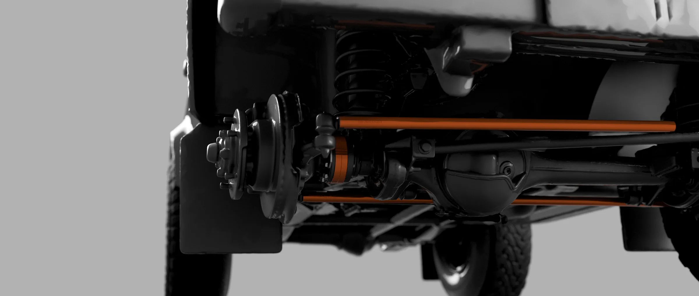 Rendering der Defender-Vorderachse mit Widetrack-Achsverbreiterung sowie orangefarbener Lenk- und Spurstange